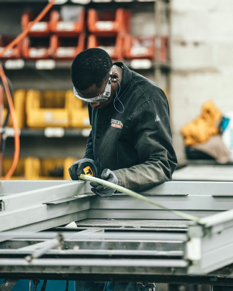 Welder fabricating a custom steel assembly in the shop