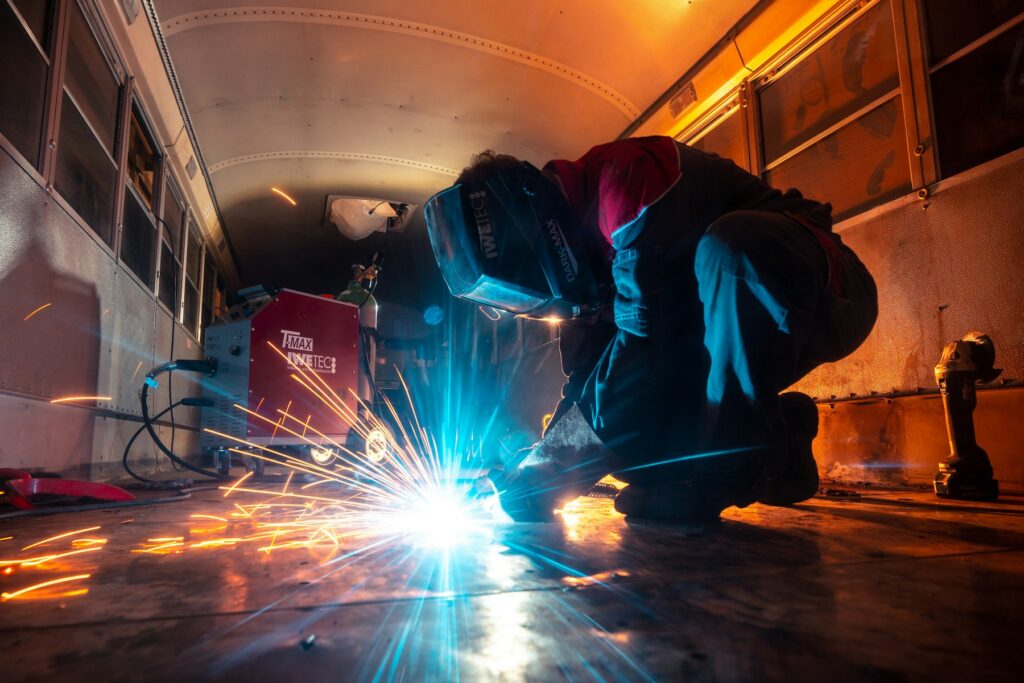 Welder making sparks while welding on site at night