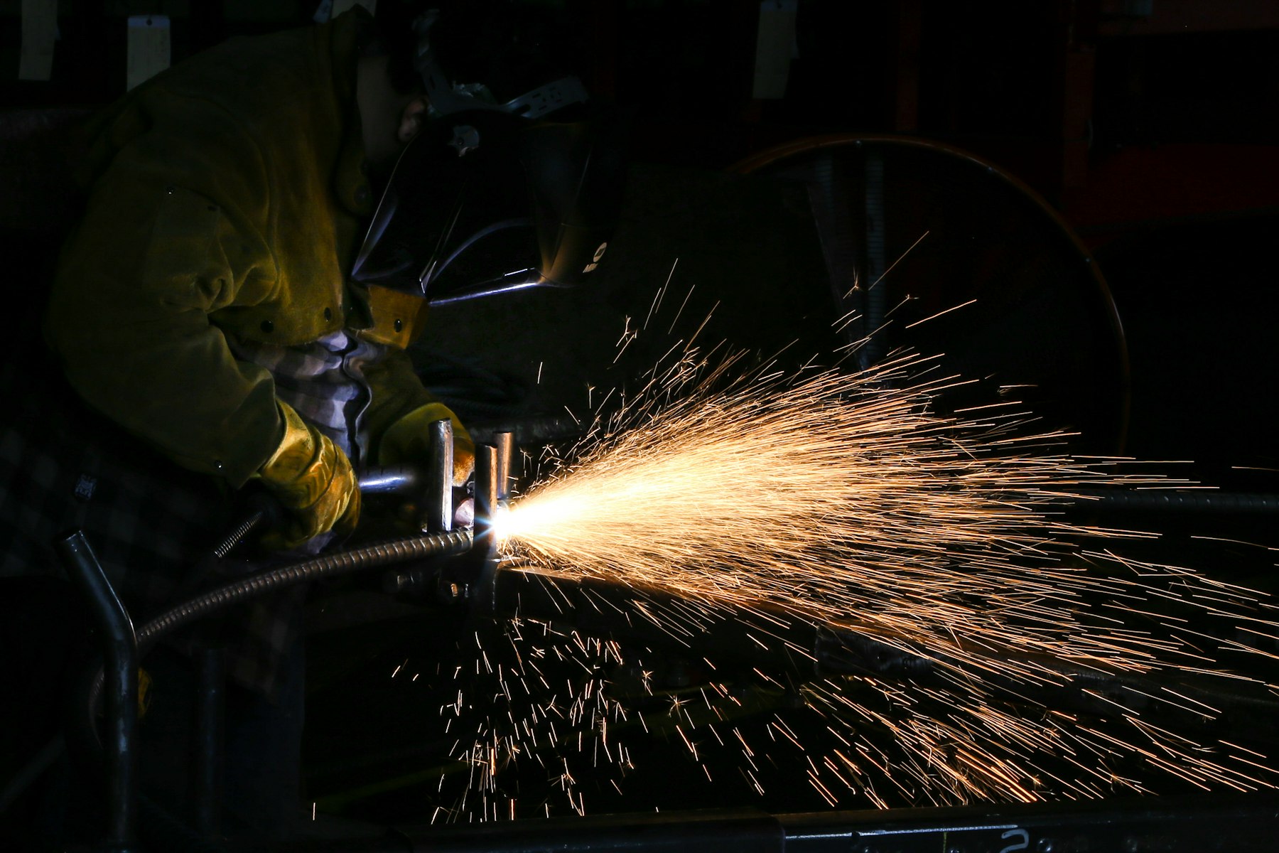 Welder at work with a bright shower of sparks
